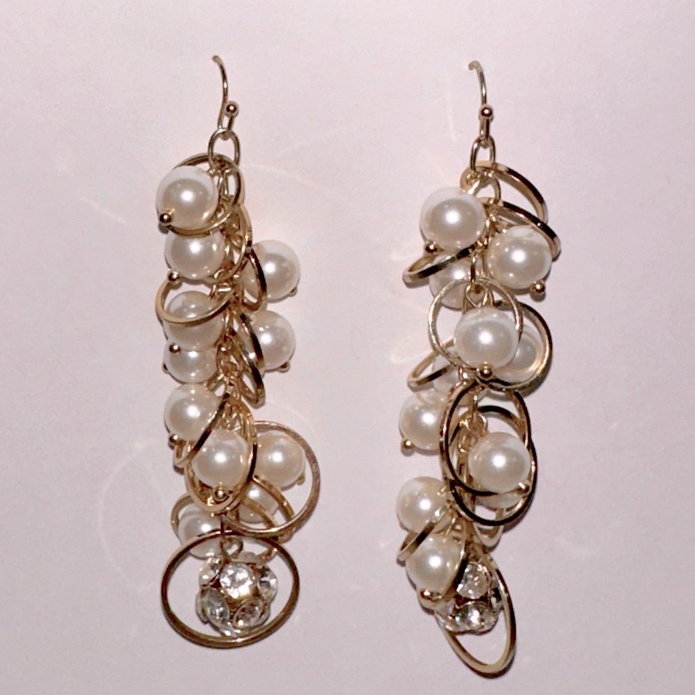Dangling gold and pearl earrings. 3 inches long. $5